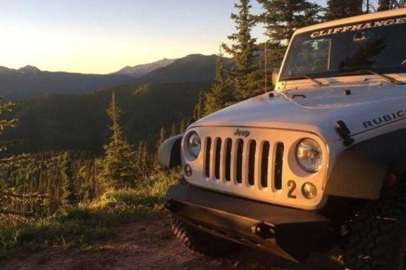 jeeps parked in front of red rocks