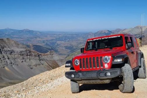 a truck is parked on the side of a mountain